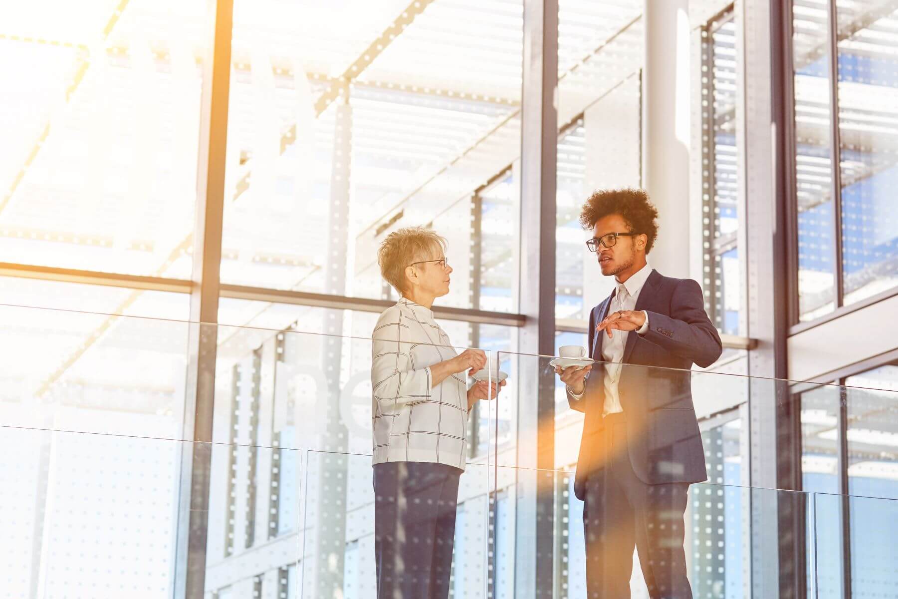 Business consultant chatting with client in an office building.
