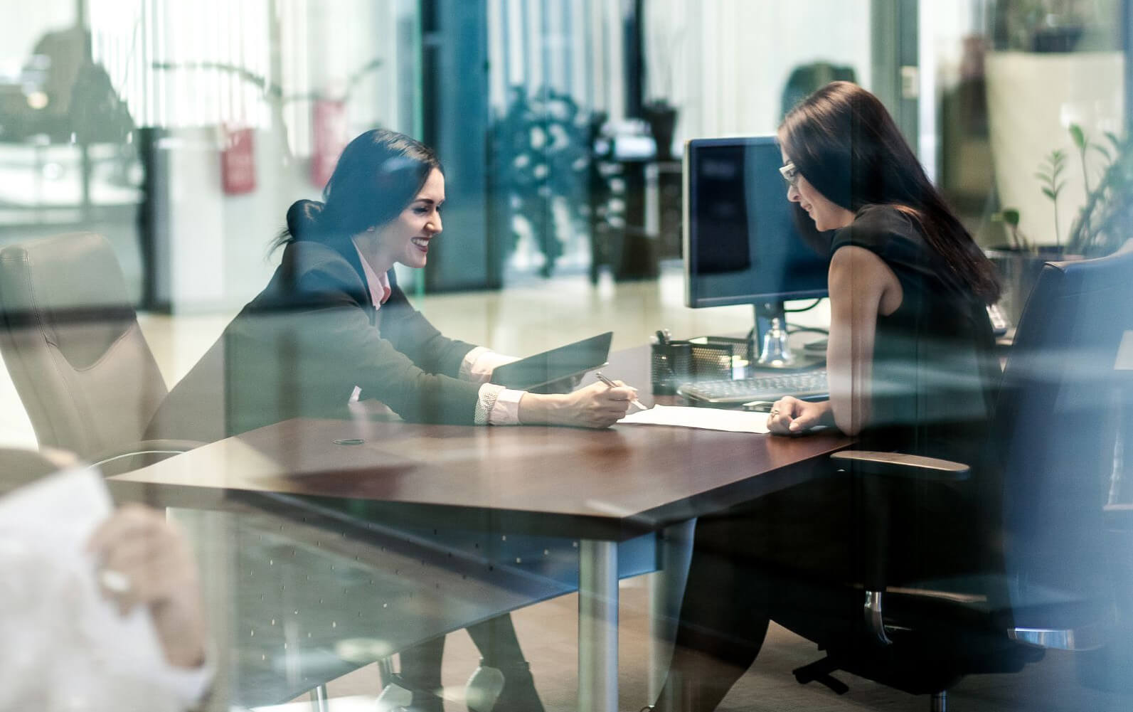 FinancialConsultantsReviewing_Compressed Financial consultants meeting in an office building